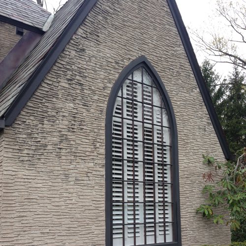 outdoor facade of stone home with plantation shutters